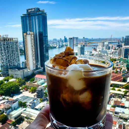 Iced coffee on the 24th floor, with the Han River and the Dragon Bridge behind it.