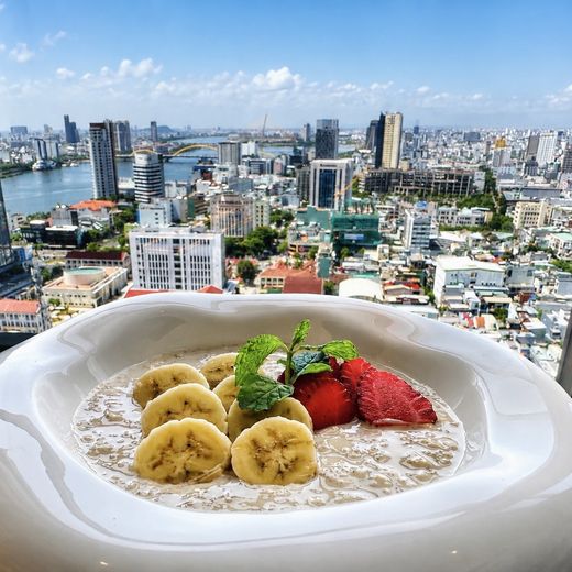 Muesli with banana and strawberry, eaten at the window. The Han River and the bridges are the actual view from the table.