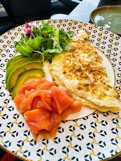 An egg-white omelette with smoked salmon, avocado and salad, cooked to order.
