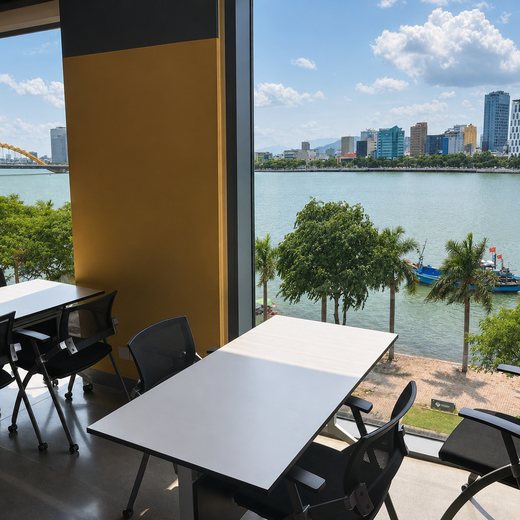 The 24/7 coworking space, with the same river view as the rooms above.