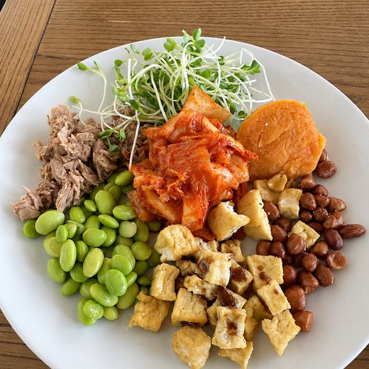 A build-your-own bowl at breakfast: tuna, edamame, kimchi, crispy tofu and peanuts.